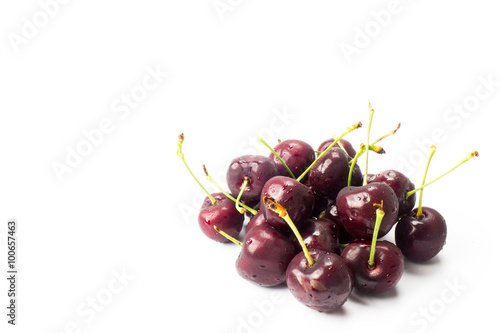 a small group of cherries arranged in a white background