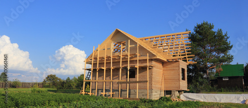 Timber house under constructoin with roof frame