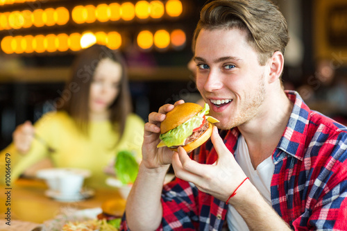 portrait of a man with a burger in his hand