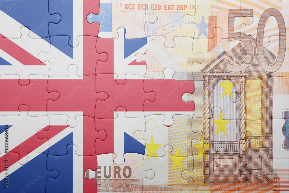 Obraz premium puzzle with the national flag of great britain and euro banknote