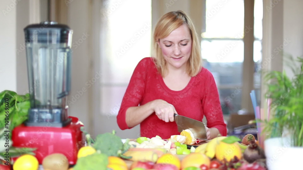 Woman cutting orange for fruit shake Woman cutting orange for fruit shake