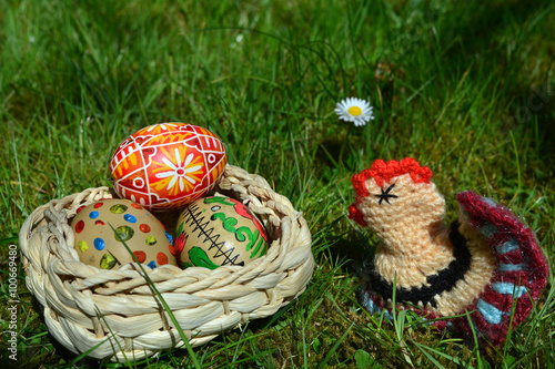 Easter Eggs with little fowl on a green grass