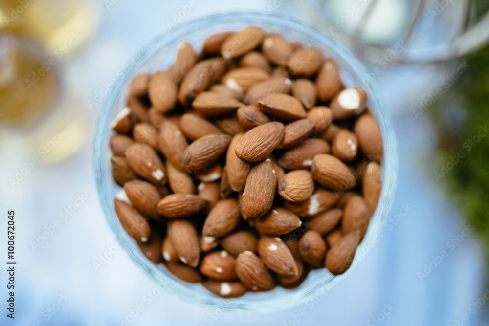 a handful of almonds in a glass vase a handful of almonds in a glass vase