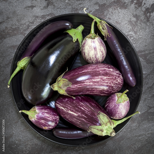 Eggplant Varieties in Black Bowl on Slate Overhead View