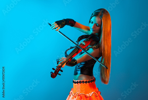 Young female violinist playing violin
