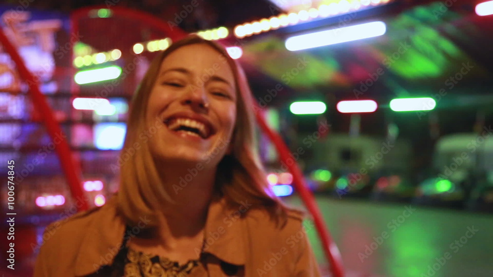 Portrait of woman looking at camera and laughing in amusement park Portrait of woman looking at camera and laughing in amusement park