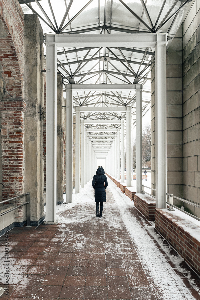 Loneliness woman walking on bridge in snowing day.