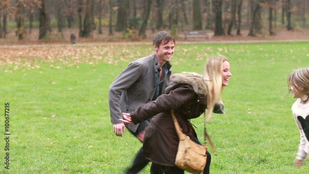 Dad trying to catch daughter while she's hiding behind mom Dad trying to catch daughter while she's hiding behind mom