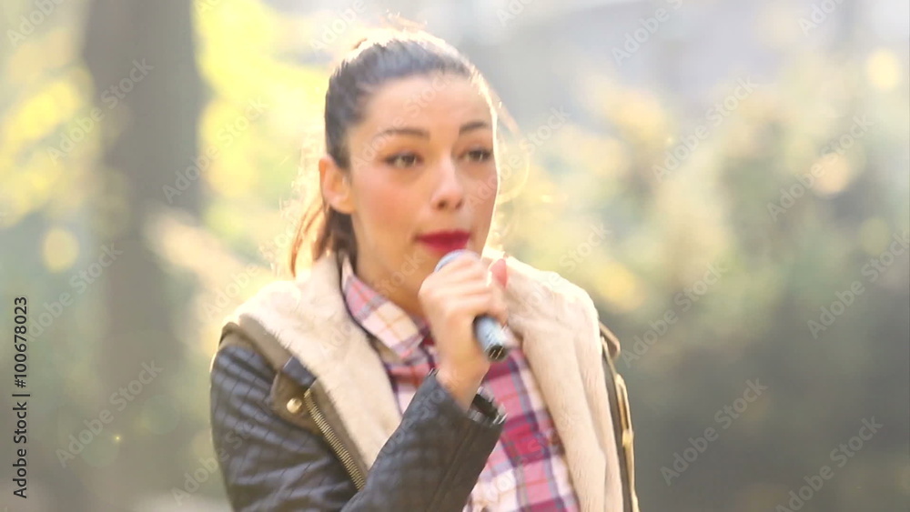 Beautiful woman singing with the microphone Beautiful woman singing with the microphone