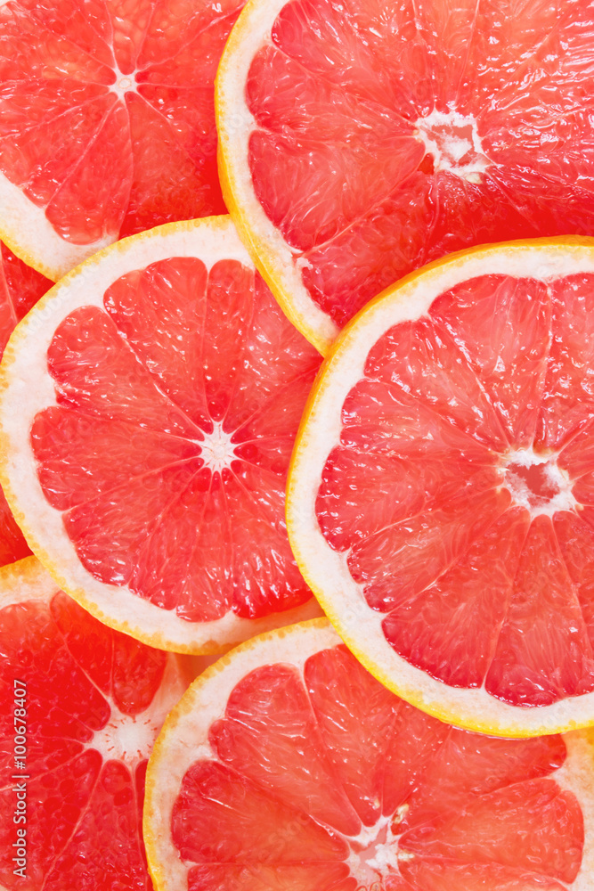 Juicy grapefruit slices as a colorful background Juicy grapefruit slices as a colorful background
