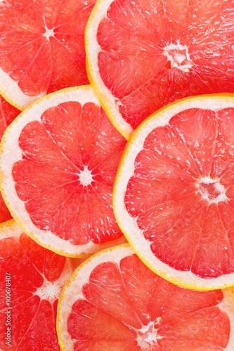 Juicy grapefruit slices as a colorful background