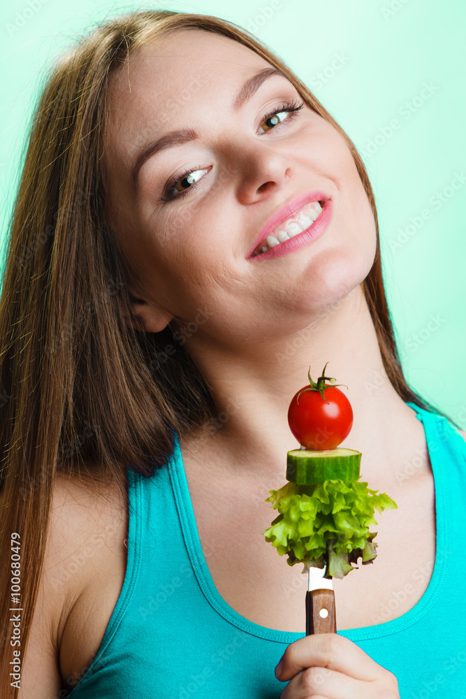 Vegetarian girl holding stack of vegetables. Vegetarian girl holding stack of vegetables.
