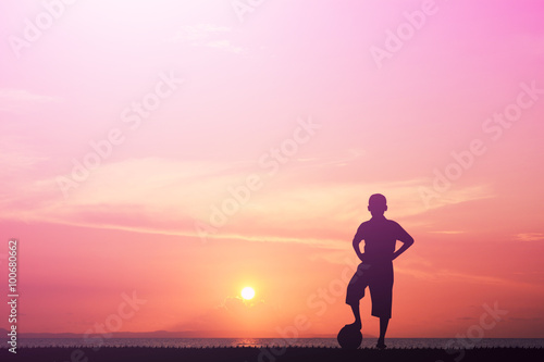 Fototapeta Naklejka Na Ścianę i Meble -  Silhouette of children playing soccer background sky