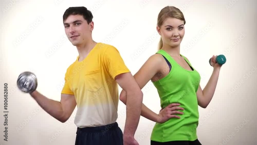 Couple exercising with dumbbells lifting weights 4K Couple exercising with dumbbells lifting weights 4K