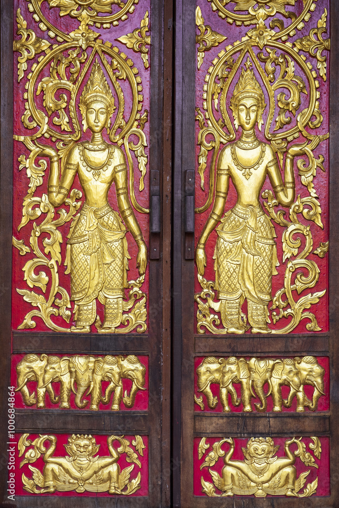 Gold carve women on red background / Chiang Mai public temple door