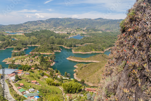 Steep Piedra del Penol rock, Colombia. Guatape dam lake in the background.