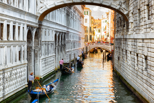 Tourists in gondolas sailing under the Bridge of Sighs in Venice