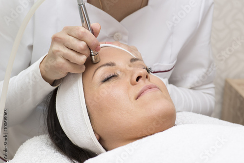Young beautiful woman gets skin treatment