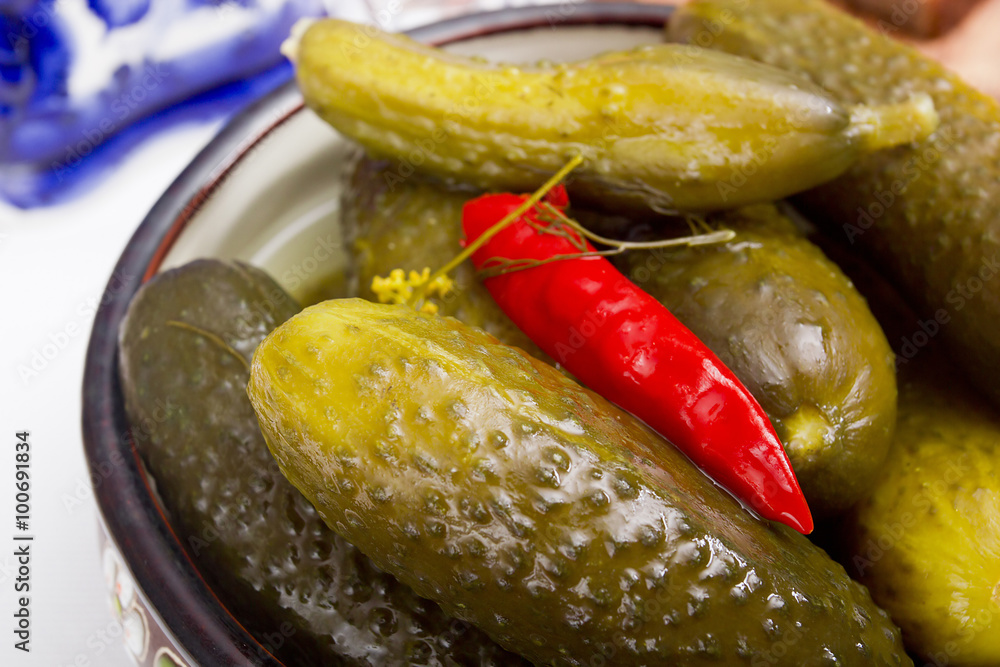 Pickled cucumbers in a clay bowl Pickled cucumbers in a clay bowl