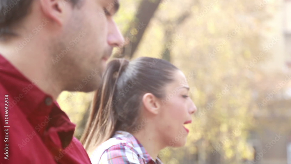 Brunette woman singing while man playing guitar Brunette woman singing while man playing guitar