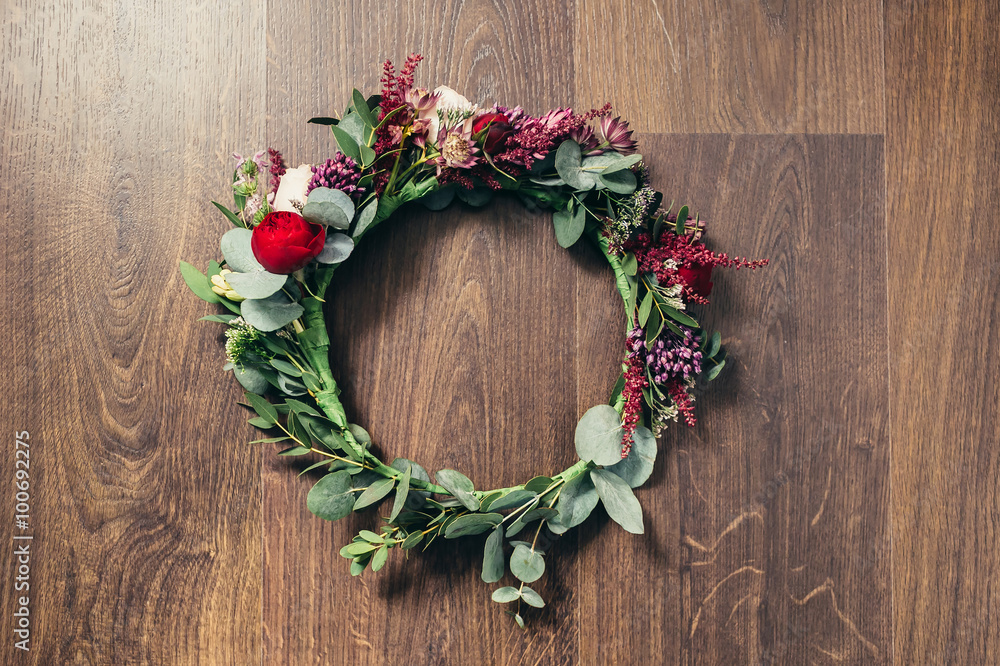 Beautiful wedding red rose flower crown on wooden background Beautiful wedding red rose flower crown on wooden background