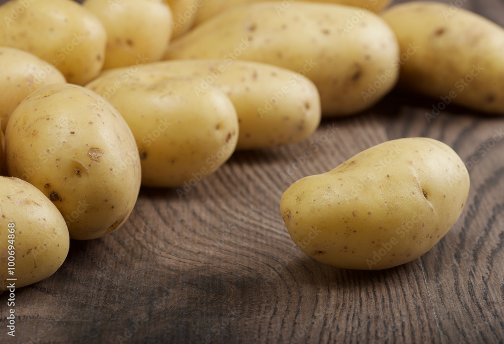 potatoes on a wooden background potatoes on a wooden background