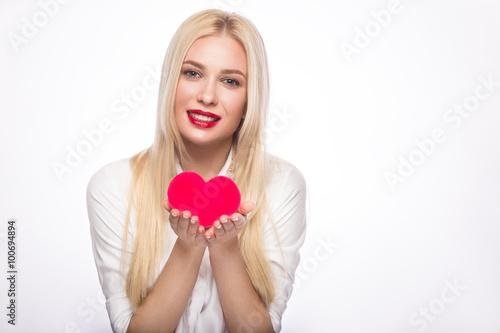 Portrait of Beautiful blond woman with bright makeup and red heart in hand. valentines day © Kobrinphoto