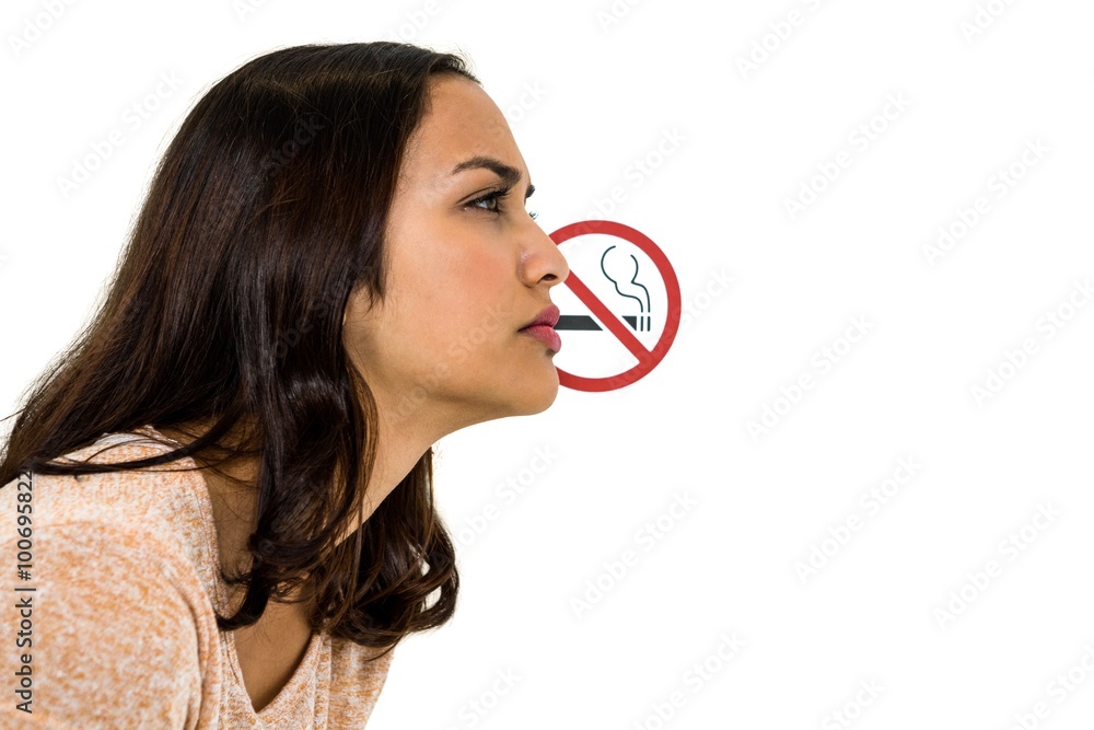 Serious woman looking away with no smoking sign Serious woman looking away with no smoking sign