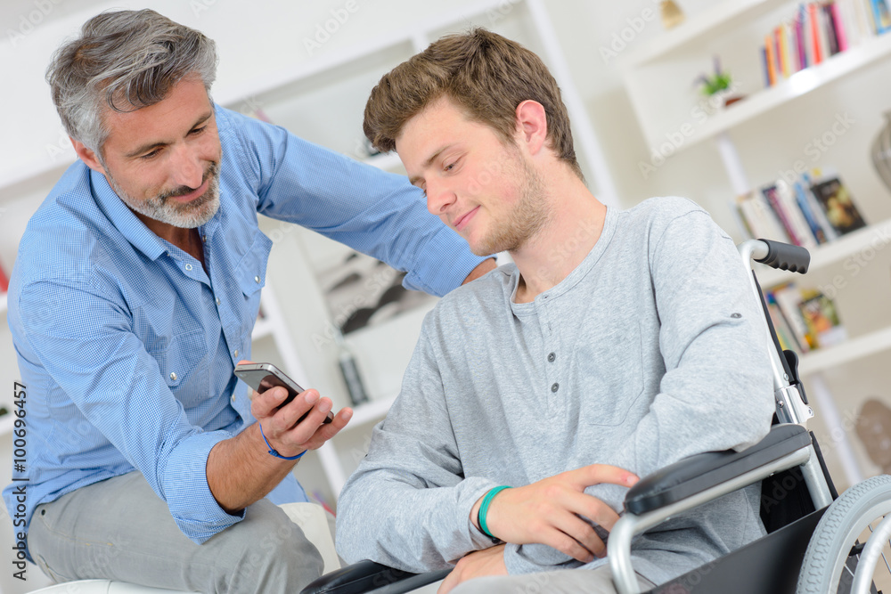man showing a message to a young man man showing a message to a young man