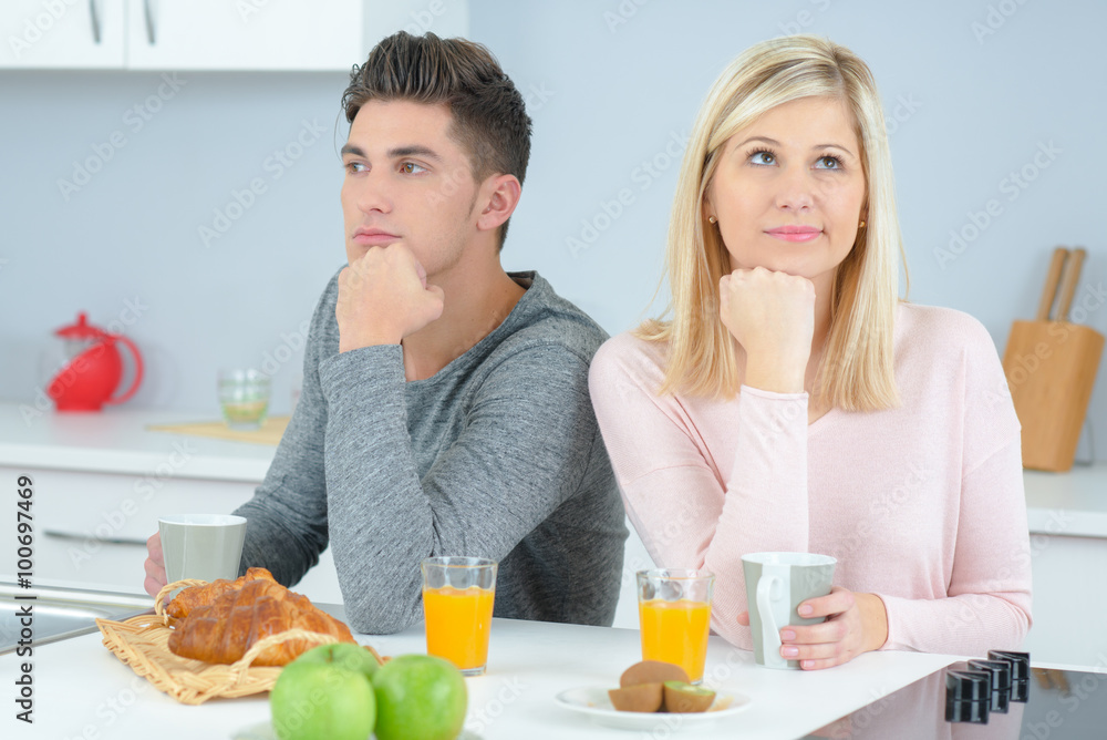 Couple in a bad mood in the kitchen Couple in a bad mood in the kitchen