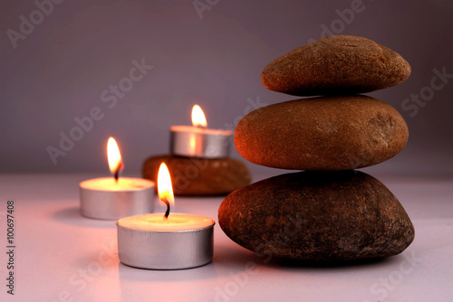 stone balance and candle flame