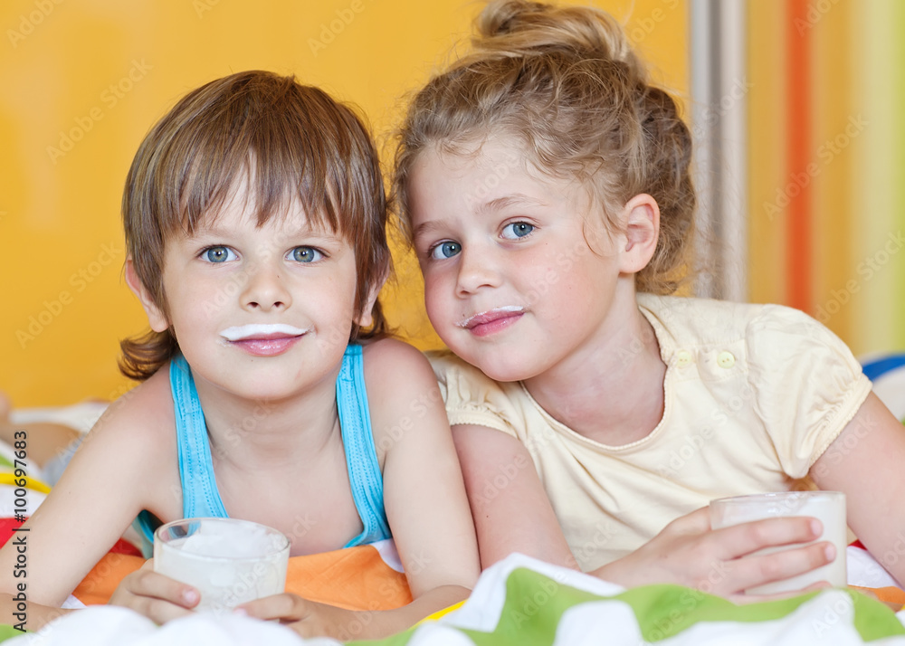 Funny kids are drinking a kefir Funny kids are drinking a kefir