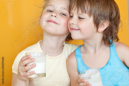 Funny kids are drinking a kefir 