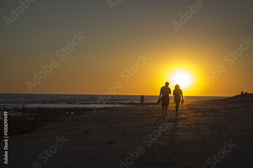 A Couple Walking In Malibu Beach Sunset