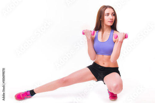 Active sportive athletic woman with dumbbells pumping up muscles biceps concept fitness sport training lifestyle