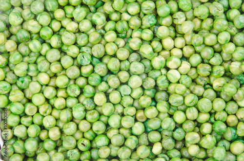nuts or crispy coated green pea on the background.