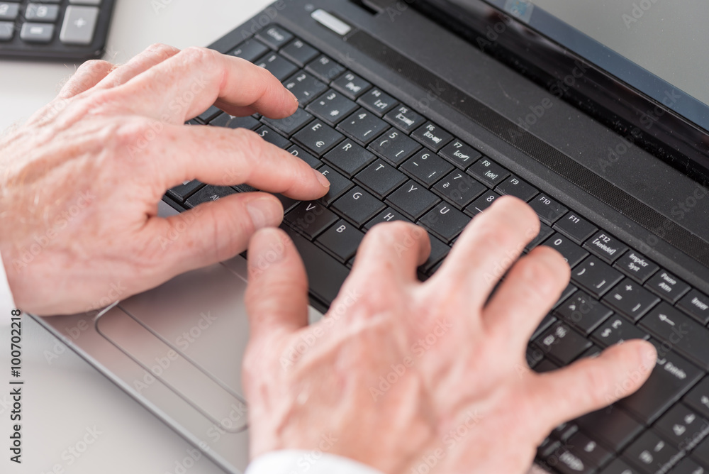 Hands typing on laptop computer Hands typing on laptop computer