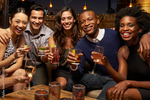 Photography Portrait Of Friends Enjoying Night Out At Rooftop Bar