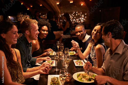 Group Of Friends Enjoying Meal In Restaurant photo