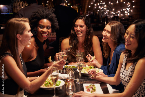 Group Of Female Friends Enjoying Meal In Restaurant