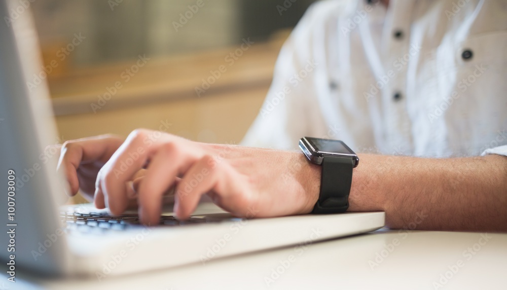 Fototapeta premium Cropped image of male student using laptop