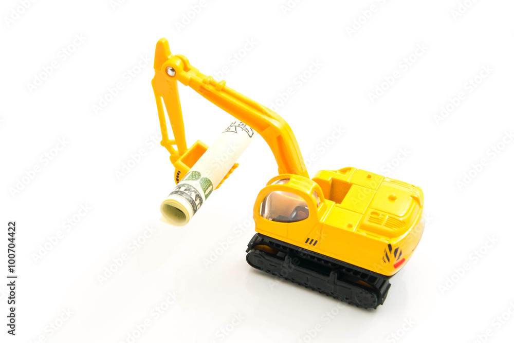 dollars banknotes and yellow backhoe