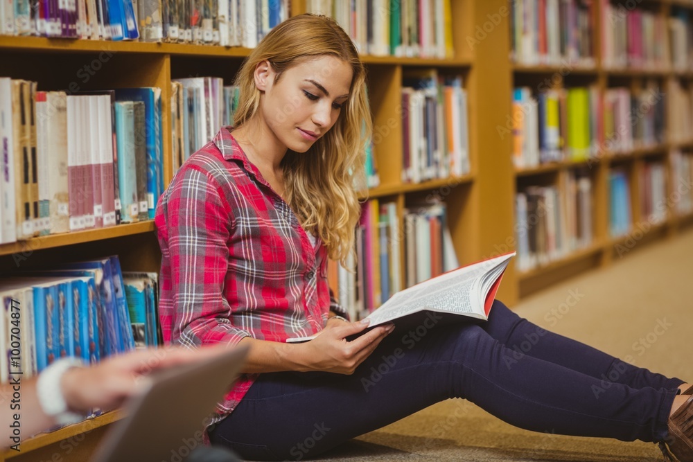 Concentrated female student working on floor Concentrated female student working on floor