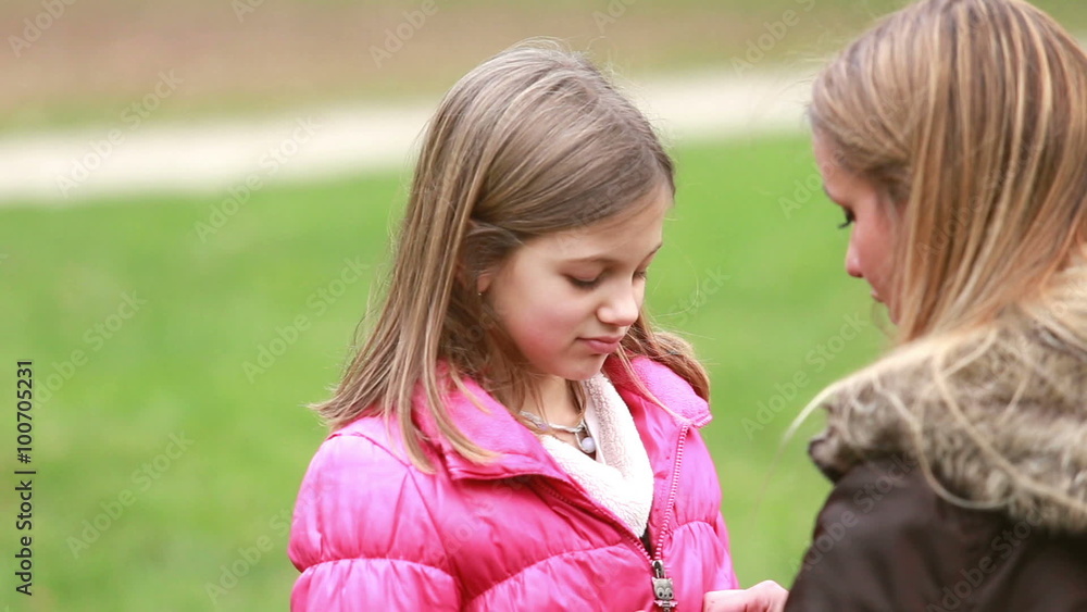 Mother zipping up daughter's jacket Mother zipping up daughter's jacket