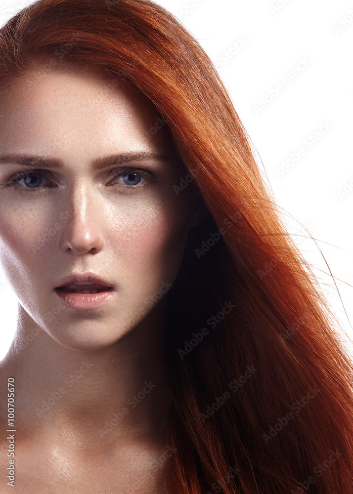 Beautiful ginger young woman with flying hair and naturel makeup