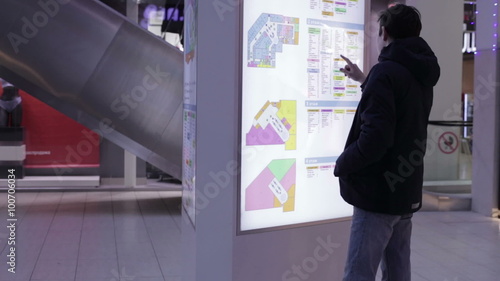 Teenager looking map of the floor plan