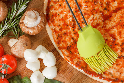 Cooking pizza with fresh ve...
