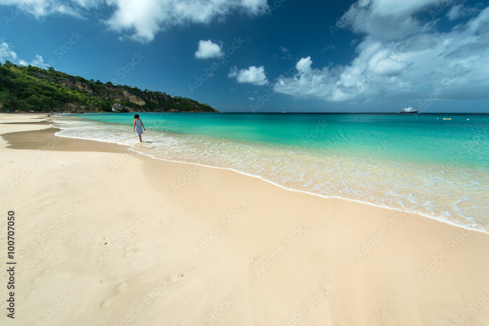 Woman is walking in a Caribbean beach