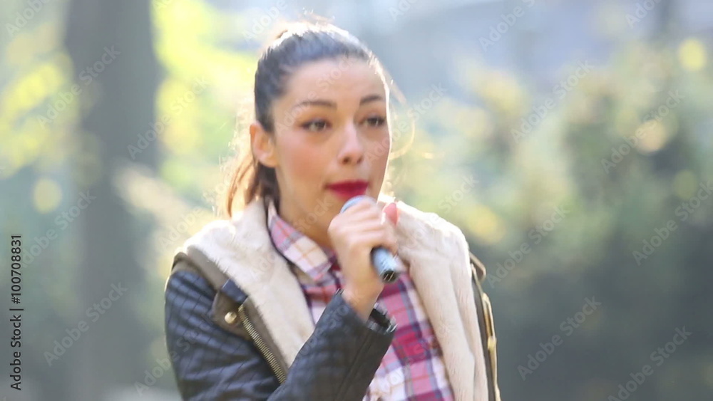Beautiful woman singing with the microphone Beautiful woman singing with the microphone