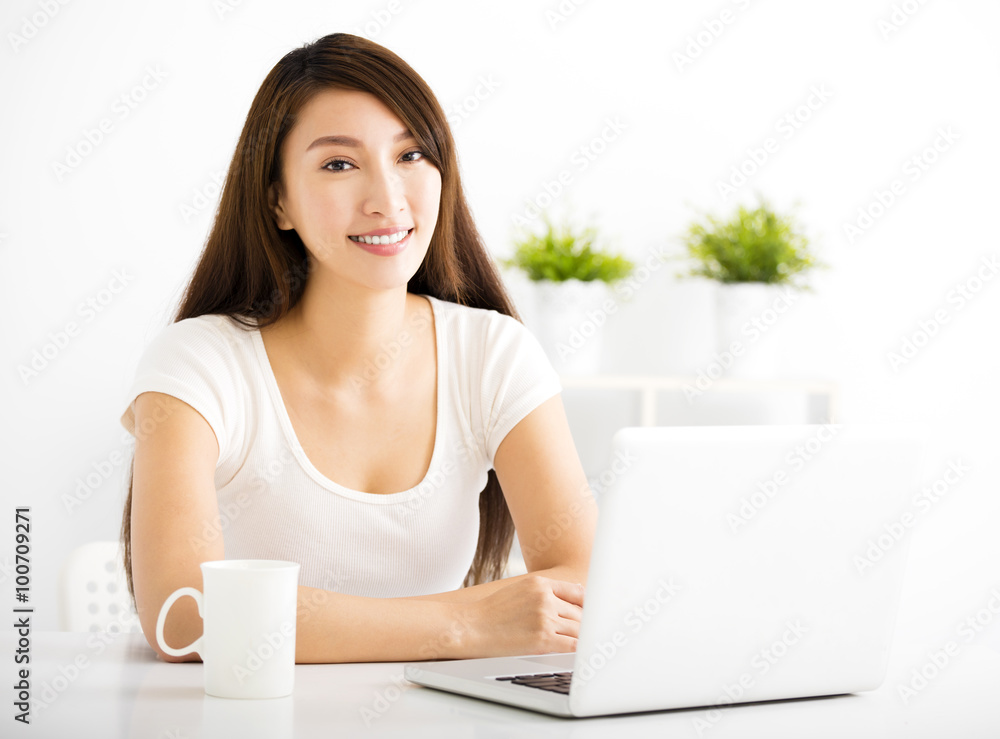 happy young woman with laptop in living room happy young woman with laptop in living room